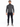 A man stands confidently in fitted evening pants paired with a turtleneck sweater and stylish sneakers.