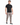 A man stands confidently in a fitted black t-shirt paired with light gray cargo pants and stylish sneakers.