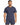 A man wearing a navy blue short-sleeve top, paired with matching shorts, stands confidently.