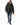 A man walks in a black puffer coat with a fur-lined hood, paired with distressed jeans and sneakers.