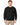 A man wearing a textured black sweatshirt with a crew neckline, paired with light-colored pants.