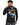 A man wearing a black long-sleeve shirt with colorful Rubik's Cube artwork and text on the back.