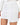 Nina Skirt Set in White – close-up of the asymmetric wrap-panel mini skirt worn with the matching blazer