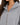 Lily Jacket Set in Grey – close-up of the silver front zip and hood on a model