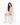 Collar Pants Set in Beige – seated model in cutout crewneck sweatshirt and cuffed joggers