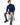 Romeo Turtleneck Sweater in Navy – seated model with ribbed cuffs and hem, worn with gray ripped jeans