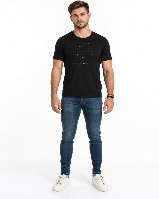 Finn Jeans in Mid Blue Wash – full-length front view on a model with a black slogan T-shirt