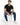 Finn Jeans in Medium Blue – seated model in faded blue wash skinny jeans with black slogan T-shirt