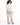 Rhea Jacket in Cream – back view with drawstring waist, worn with beige wide-leg pants