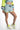 Light blue Alexia crop top and drawstring dolphin shorts with neon yellow accents for a trendy summer look.