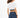 Back view of a woman wearing a white cropped ribbed tee with a striped elastic hem and blue slim-fit jeans.