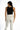 Back view of the Evie Sleeveless Bodysuit in Carbon black styled with high-waisted white trousers for a sleek OOTD.