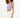 Model wearing a lavender Marne ribbed tank top with a square neckline and white denim shorts against a white background.