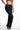 Front view of Nora high-waisted flare jeans in dark indigo wash denim with retro 70s-style silhouette and five pockets.
