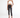 Model wearing a Carbon Knit cream halter crop top and black high-waisted skinny jeans with heels.