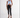 Model wears the Tori light blue ribbed halter top with front cutouts and metal ring details, paired with black jeans.