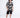 Men's black Miami shirt with white beach-themed typography, worn with black shorts and white sneakers.