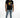 Man in Carbon Memories Graphic T-Shirt in black with streetwear print, light wash ripped denim, and white sneakers.