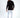 Back view of a man in a black long-sleeve streetwear shirt, white slim-fit jeans, and black sneakers.
