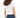 Back view of L.A. Vibes White Crop Top, a streetwear essential paired with dark blue jeans on a curly-haired model.