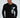 Man in a black Never Give Up long-sleeve streetwear graphic tee with geometric gray print and white pants.