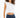 Model in Carbon Maya Padded Crop Top in white with elastic hem and blue jeans against a white background.