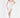 A model poses in a fitted white dress with a thigh-high slit and delicate straps, paired with beige heels.