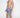 Model wearing blue Hank Swimwear patterned swim trunks with white palm leaf prints and drawstring elastic waistband.