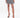Model wearing a black and white leopard print pleated mini skirt with high-waisted fit and black strappy heels.